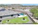 Aerial view showcases a desert home with backyard pool, patio, desert landscaping, and solar panels at 18000 W Thistle Landing Dr, Goodyear, AZ 85338