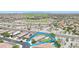 An aerial view highlights a neighborhood with mountain views and nearby desert landscaping at 18000 W Thistle Landing Dr, Goodyear, AZ 85338