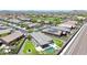 Overhead view of a well-maintained community featuring homes with desert landscaping, and tile roofs at 18000 W Thistle Landing Dr, Goodyear, AZ 85338