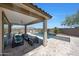 Gorgeous backyard featuring a covered patio, a sparkling pool, and low-maintenance desert landscaping at 18000 W Thistle Landing Dr, Goodyear, AZ 85338