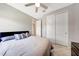 Inviting bedroom with ceiling fan, closet, and comfortable bed at 18000 W Thistle Landing Dr, Goodyear, AZ 85338