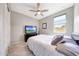 Cozy bedroom with ceiling fan, natural light, and comfortable bed at 18000 W Thistle Landing Dr, Goodyear, AZ 85338