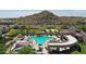 An aerial view of the large pool, shaded seating, and well-maintained landscaping at the center at 18000 W Thistle Landing Dr, Goodyear, AZ 85338