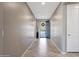 Charming entryway with a blue door and security screen and neutral colored tile floors at 18000 W Thistle Landing Dr, Goodyear, AZ 85338