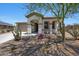 Inviting single-story home with desert landscaping and an attached two car garage at 18000 W Thistle Landing Dr, Goodyear, AZ 85338