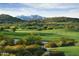 Scenic golf course with mountain views and lush greenery in a tranquil setting at 18000 W Thistle Landing Dr, Goodyear, AZ 85338