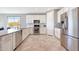 Modern kitchen featuring white cabinets, stainless steel appliances, and tile flooring at 18000 W Thistle Landing Dr, Goodyear, AZ 85338