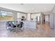 Open concept kitchen with dining area, white cabinets, and natural light at 18000 W Thistle Landing Dr, Goodyear, AZ 85338
