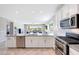 Bright kitchen features stainless steel appliances, granite countertops, and an open concept to the living room at 18000 W Thistle Landing Dr, Goodyear, AZ 85338