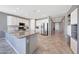 Spacious kitchen featuring white cabinets, granite countertops, and stainless steel appliances at 18000 W Thistle Landing Dr, Goodyear, AZ 85338