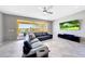 Inviting living room with a view of the pool and outdoor area through large sliding glass doors at 18000 W Thistle Landing Dr, Goodyear, AZ 85338