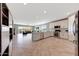 Bright, open-concept living space combining the living room, dining area, and kitchen for seamless entertaining at 18000 W Thistle Landing Dr, Goodyear, AZ 85338