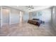 Bright main bedroom with ceiling fan, tile floors, and ample space at 18000 W Thistle Landing Dr, Goodyear, AZ 85338