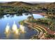 Scenic community pond with fountains, walking paths, and lush landscaping at 18000 W Thistle Landing Dr, Goodyear, AZ 85338