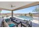 Relaxing outdoor living space with a covered patio, comfortable seating, and a sparkling pool with waterfall feature at 18000 W Thistle Landing Dr, Goodyear, AZ 85338