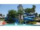 Resort-style community pool featuring thrilling waterslides and a charming lighthouse at 18000 W Thistle Landing Dr, Goodyear, AZ 85338