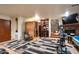 Finished basement area with gym, bar, sauna, and fireplace at 18425 W Santa Irene Dr, Goodyear, AZ 85338
