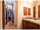 Bathroom with a granite vanity and a view into the bedroom at 18425 W Santa Irene Dr, Goodyear, AZ 85338