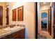 Bathroom with granite vanity and wood cabinets at 18425 W Santa Irene Dr, Goodyear, AZ 85338