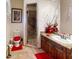 Bathroom featuring a glass-enclosed shower, granite countertops, custom cabinets, and neutral tiling at 18425 W Santa Irene Dr, Goodyear, AZ 85338