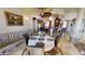 Elegant dining room features a round table with seating for four, next to an open-concept kitchen and stone accents at 18425 W Santa Irene Dr, Goodyear, AZ 85338