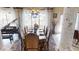 Dining room featuring a large dining table, piano, columns, and chandelier at 18425 W Santa Irene Dr, Goodyear, AZ 85338