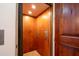 Interior view of the residential elevator featuring wood paneling and controls at 18425 W Santa Irene Dr, Goodyear, AZ 85338