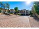 Beautiful home features a three-car garage, decorative stone accents, and desert landscaping on a sunny day at 18425 W Santa Irene Dr, Goodyear, AZ 85338