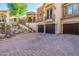 Stunning home featuring a three-car garage, decorative stone accents, and professionally landscaped desert-style yard at 18425 W Santa Irene Dr, Goodyear, AZ 85338