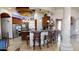 Gourmet kitchen with custom cabinetry, stainless steel appliances, and a breakfast bar with seating at 18425 W Santa Irene Dr, Goodyear, AZ 85338