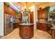 Spacious kitchen with custom cabinets, stainless steel appliances, granite countertops, and a large center island with sink at 18425 W Santa Irene Dr, Goodyear, AZ 85338