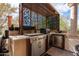 The outdoor kitchen features stainless steel appliances and a convenient beverage fridge at 18425 W Santa Irene Dr, Goodyear, AZ 85338