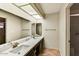 Modern bathroom featuring double sinks, spacious countertops, and a walk-in shower at 19025 N 96Th Ave, Peoria, AZ 85382