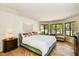 Serene bedroom with large windows, comfortable seating area, and stylish decor at 19025 N 96Th Ave, Peoria, AZ 85382