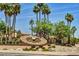 Elaborate clock with floral details set amongst a desert landscaped setting, showcasing community beauty at 19025 N 96Th Ave, Peoria, AZ 85382