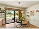 Cozy dining area with glass table, stylish chairs, and sliding glass doors leading to backyard at 19025 N 96Th Ave, Peoria, AZ 85382