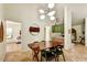 Elegant dining room with wood table, modern lighting, and open access to the living room and kitchen at 19025 N 96Th Ave, Peoria, AZ 85382