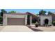Charming single-story home with a well-manicured yard, desert landscaping, and a two-car garage at 19025 N 96Th Ave, Peoria, AZ 85382