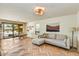 Comfortable living room featuring wood floors, natural light, and a seamless transition to the dining area at 19025 N 96Th Ave, Peoria, AZ 85382