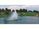 Scenic golf course pond with a fountain, lush green surroundings, and blue skies with fluffy clouds at 19025 N 96Th Ave, Peoria, AZ 85382