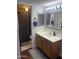 Updated bathroom with wood vanity, framed mirror, modern lighting, and shower at 1920 W Lindner Ave # 222, Mesa, AZ 85202