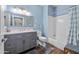 Modern bathroom with blue walls, gray vanity with granite countertops, and a shower-tub combo at 1941 S Pierpont Dr # 2015, Mesa, AZ 85206