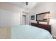 Bright bedroom with a large dresser, mirror, sliding-door closet, and beige and blue bedding at 1941 S Pierpont Dr # 2015, Mesa, AZ 85206