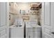 Laundry room with a white washer, dryer, wire shelving, and a door for easy access at 1941 S Pierpont Dr # 2015, Mesa, AZ 85206