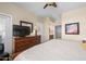 Comfortable main bedroom with ceiling fan, dresser and bathroom view at 1941 S Pierpont Dr # 2015, Mesa, AZ 85206
