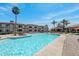 Community pool with plenty of lounge chairs for relaxing and palm trees for shade at 1941 S Pierpont Dr # 2015, Mesa, AZ 85206
