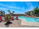 Community pool with plenty of lounge chairs and palm trees creating a resort-like experience at 1941 S Pierpont Dr # 2015, Mesa, AZ 85206