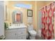 Bathroom with white vanity, decorative mirror, patterned shower curtain, and tiled floor at 19714 N Concord Dr, Surprise, AZ 85374