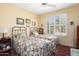 Cozy bedroom featuring two twin beds, a ceiling fan, and plantation shutters at 19714 N Concord Dr, Surprise, AZ 85374