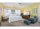 Well-lit primary bedroom with a ceiling fan and lots of natural light at 19714 N Concord Dr, Surprise, AZ 85374